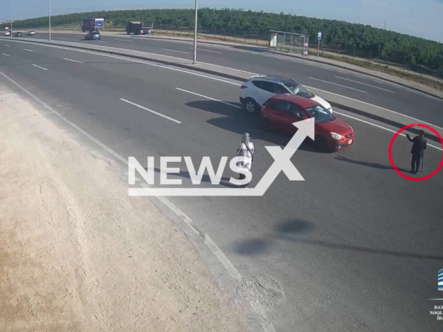 This image is a screen grab of the video supplied titled NewsX-MotorwayCross-01.mp4: Footage shows an older pedestrian trying to cross the road, causing a crash on the Qala-Pirallahi road in Baku, Azerbaijan on Wednesday, May 21, 2025.(Clipzilla/NX)