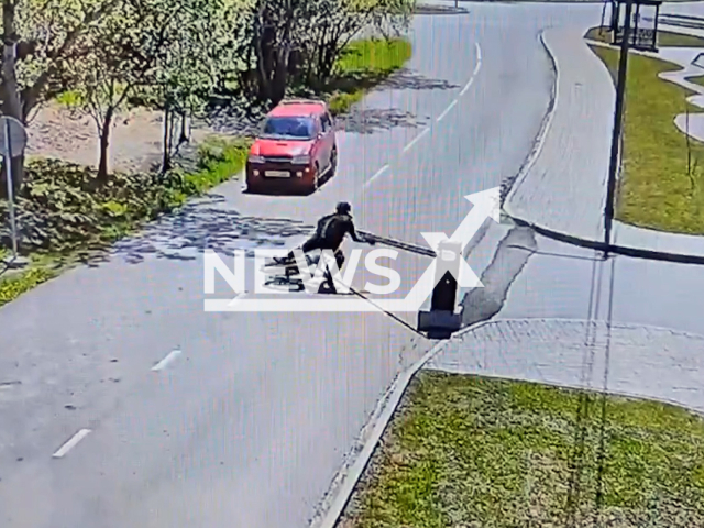 This image is a screen grab of the video supplied titled NewsX-CyclistBarrier-01.mp4: A cyclist knocks down a park barrier in Korsakov, Sakhalin Oblast, Russia on Saturday, May 24, 2025. (Clipzilla/NX)