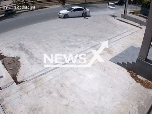 This image is a screen grab of the video supplied titled NewsX-MissRoad-01.mp4: A young woman narrowly missed being hit by a speeding car near Gudauta,  Abkhazia, Georgia on Friday, May 23, 2025. (Clipzilla/NX)