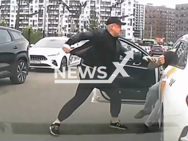 This image is a screen grab of the video supplied titled NewsX-LaneDispute-01.mp4: Dash camera shows a man and a woman beating the taxi driver over a line dispute in Kudrovo, Russia on Sunday, May 25, 2025.(Clipzilla/NX)