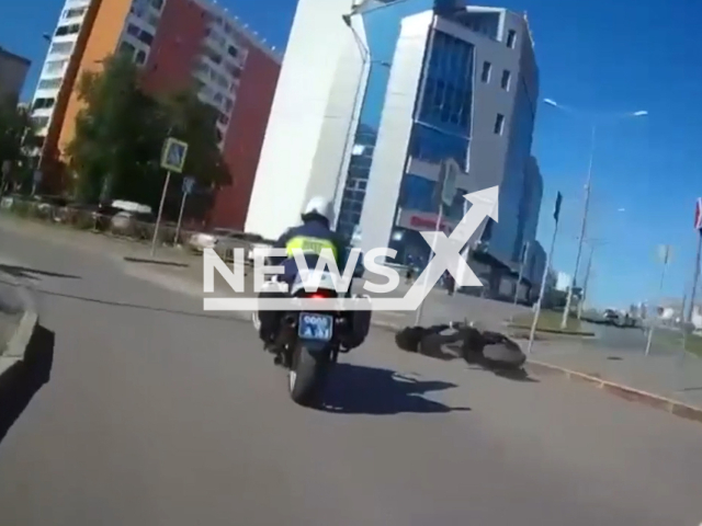 This image is a screen grab of the video supplied titled NewsX-BikerFine-01.mp4: Footage shows a police officer apprehending the suspect after a short bike chase in Samara, Russia on Sunday, May 25, 2025.(Clipzilla/NX)