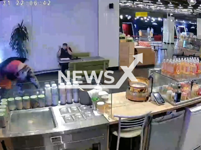 This image is a screen grab of the video supplied titled NewsX-DrunkFlare-01.mp4: A drunken man shoots in the head with a flare gun the actor of "Streets of Broken Lights" now a security guard, the 48-year-old Valery Muzyka in the shopping center "Mercury" in Russia on Saturday, May 31, 2025.(Clipzilla/NX)
