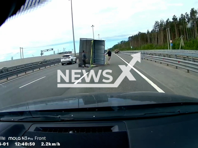 This image is a screen grab of the video supplied titled NewsX-CanopyRoad-01.mp4: Dashcam footage shows strong winds blowing a car canopy onto the ring road at Krasnoselsky District, Saint Petersburg, Russia, on Sunday, June 1, 2025.(Clipzilla/NX)