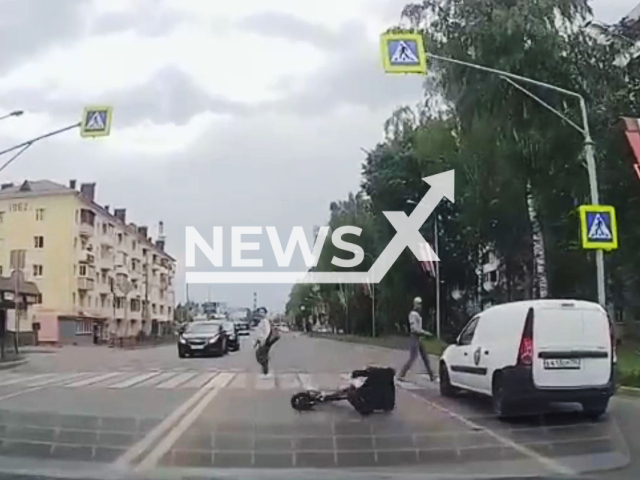 This image is a screen grab of the video supplied titled NewsX-BrakeFall-01.mp4: Dashcam footage shows a man on a scooter suddenly braking in front of a pedestrian crossing and falling over it in Kalin, Moscow Oblast, Russia, on Friday, May 30, 2025.(Clipzilla/NX)