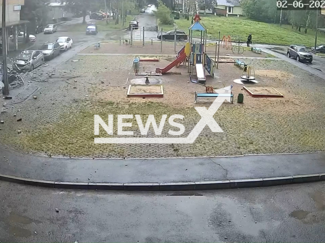 This image is a screen grab of the video supplied titled NewsX-BricksDamage-01.mp4: CCTV footage shows brickwork collapsing from the roof of a building on the parked vehicles in front of it in Cheboksary, Russia, on Monday, June 2, 2025.(Clipzilla/NX)