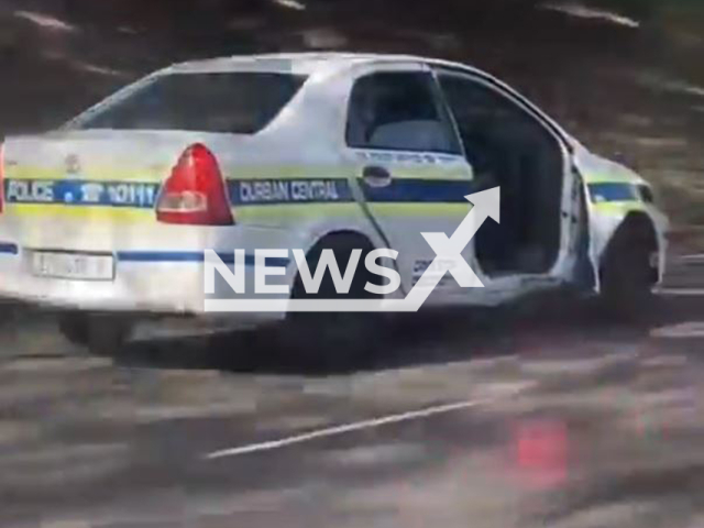 This image is a screen grab of the video supplied titled NewsX-CopsRiders-01.mp4: An officer drives a doorless police car on the road in Durban North, KwaZulu-Natal, South Africa on Sunday, June 1, 2025.(Clipzilla/NX)