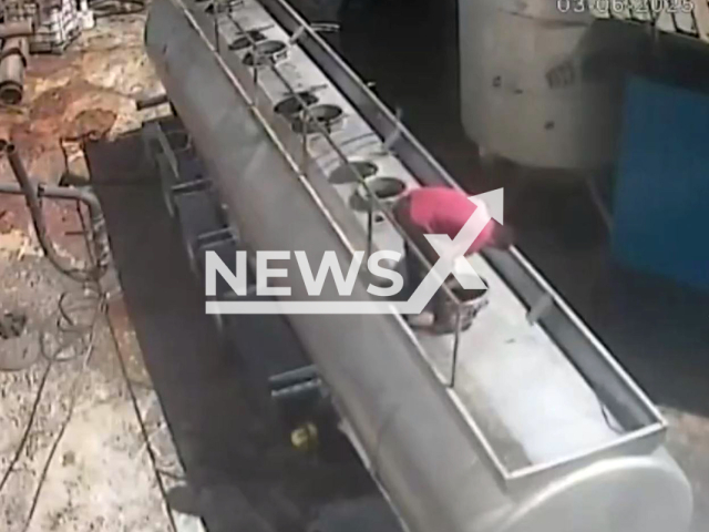 This image is a screen grab of the video supplied titled NewsX-CigaretteTanker-01.mp4: Footage shows a man being catapulted after opening a tanker hatch with a cigarette in his mouth at a sunflower oil factory in the Nizip district of Gaziantep, Turkey on Tuesday, June 3, 2025.(Clipzilla/NX)