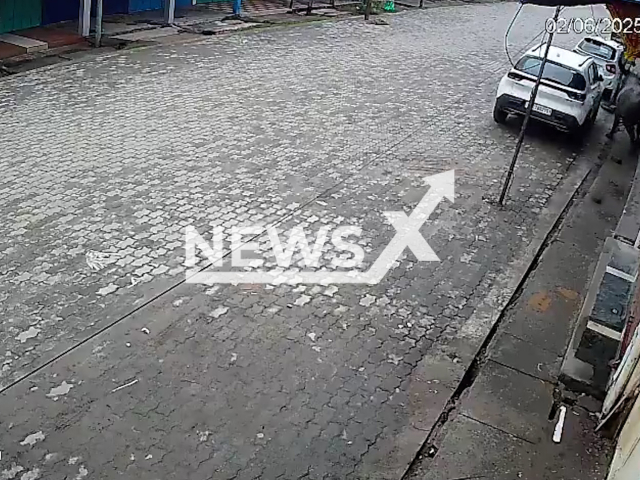 This image is a screen grab of the video supplied titled NewsX-RampagingBull-01.mp4: CCTV shows a buffalo attacking and killing a man in Tezpur, Assam state, India on Monday, June 2, 2025. ( Clipzilla/NX)