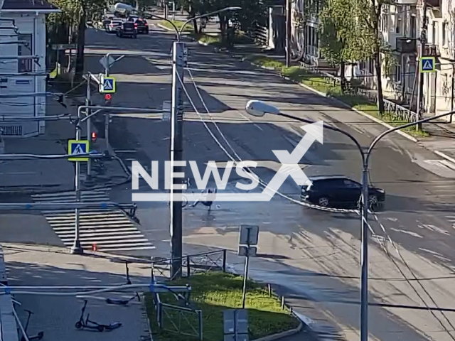 This image is a screen grab of the video supplied titled NewsX-CyclistInjured -01.mp4: CCTV shows a cyclist ignoring the red light being hit by a Ford Focus along Chekhov Street towards the Mira-Chekhov intersection in Vologda, Russia on Wednesday, June 4, 2025.(Clipzilla/NX)