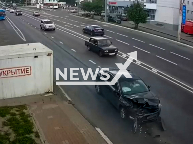 This image is a screen grab of the video supplied titled NewsX-StopPickUp-01.mp4: Video shows a Mitsubishi Lancer stopping at a bus stop to pick up a passenger, leading to a high-speed crash with a Ford Mondeo after a Kia Stinger narrowly avoided it in Belgorod, Russia on Tuesday, June 3, 2025.(Clipzilla/NX)