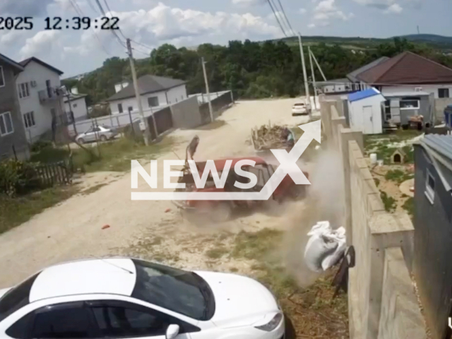 This image is a screen grab of the video supplied titled NewsX-CarPowExplode-01.mp4: CCTV footage shows a car exploding, with thick white smoke pouring out of the cabin in Novorossiysk, Russia on Tuesday, June 3, 2025. (Clipzilla/NX)