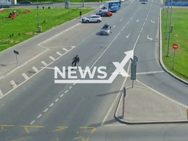 This image is a screen grab of the video supplied titled NewsX-UnicycleRider-01.mp4: Footage shows a man recklessly riding an unhelmeted unicycle on a busy road in Moscow, Russia, undated. The State Traffic Safety Inspectorate of Moscow posted the footage on Wednesday, May 28, 2025. (Clipzilla/NX)