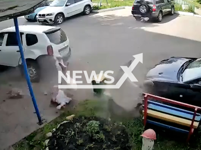This image is a screen grab of the video supplied titled NewsX-RenaultDuster-01.mp4: Drunk driver hits woman and crashes into a parked car in Borodino, Russia, on 8 June, 2025. The victim was taken to hospital with multiple injuries.(Clipzilla/NX)