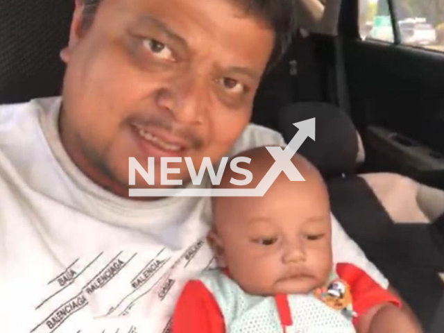 Photo shows Nurul Effendy Ibrahim and his baby son, Muhammad Nur Daniel Nurul Effendy, undated. The baby died crushed under his father's arm who suffered a fatal heart attack at home in Malacca City, Malaysia, on 19 June 2025. Note: Private photo. (Newsflash/NX)
