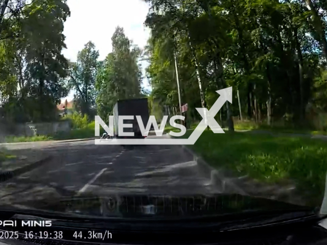 This image is a screen grab of the video supplied titled NewsX-TruckTurnInj-01.mp4: A truck hits a scooter rider after a sudden turn on Lesnoy Prospect, Saint Petersburg, Russia, on Monday, June 23, 2025.(Clipzilla/NX)