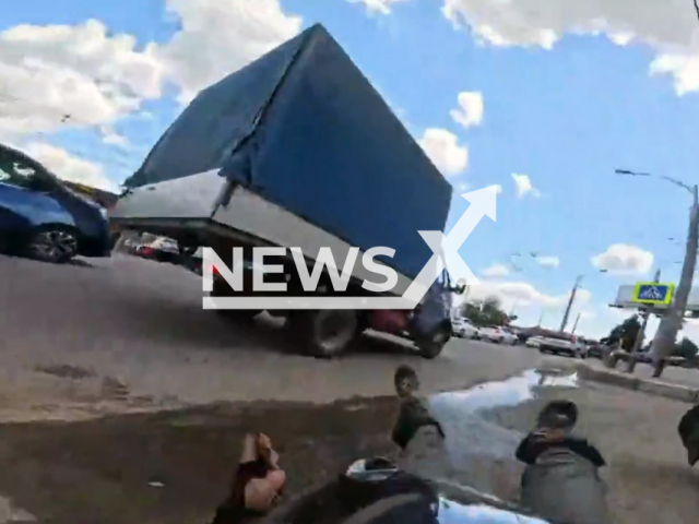 This image is a screen grab of the video supplied titled NewsX-OvertakeUnicycle-01.mp4: Footage shows an unicycle rider driving between the two lines of cars on the street and suddenly crashing into a GAZelle truck in Krasnodar, Russia, undated. Footage was published on Vkontakte on Wednesday, June 25, 2025.