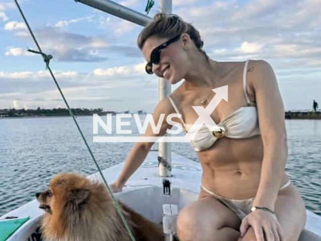 Lawyer Maria Eduarda Medeiros, 38, poses with dog in undated photo. She disappeared at sea after a speedboat accident on Suape beach, in Cabo de Santo Agostinho, in Greater Recife, Brazil. Note: Private photo. (Newsflash/NX)