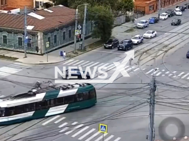 This image is a screen grab of the video supplied titled NewsX-TramRoof-01.mp4: A tram's pantograph tears off at an intersection, halting tram traffic in Chelyabinsk on Thursday, June 26, 2025.