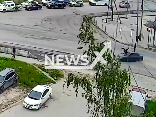This image is a screen grab of the video supplied titled NewsX-FourTeenHit-01.mp4: Footage shows an 18-year-old hitting a 14-year-old girl who was crossing the roadway at a pedestrian crossing when the traffic light was red in Nefteyugansk in Khanty-Mansi Autonomous Okrug, Russia on Wednesday, June 25, 2025.(Clipzilla/NX)