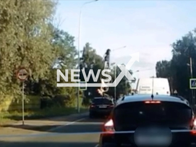 This image is a screen grab of the video supplied titled NewsX-WrongLaneFly-01.mp4: Footage shows the driver, driving a passenger car, driving around a traffic jam in the lane intended for oncoming traffic and colliding with a pit bike moving towards her on its rear wheel, driven by a 14-year-old driver in Lugovoe, the Gurevsky urban district of the Kaliningrad region, Russia on Thursday, June 26, 2025.(Clipzilla/NX)