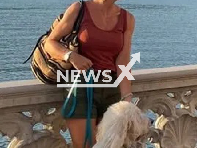 Ina Z. poses with her poodle on a beach promenade in Mallorca, Spain, undated. She faked her own death to escape justice. Note: Private photo. (Newsflash/NX)