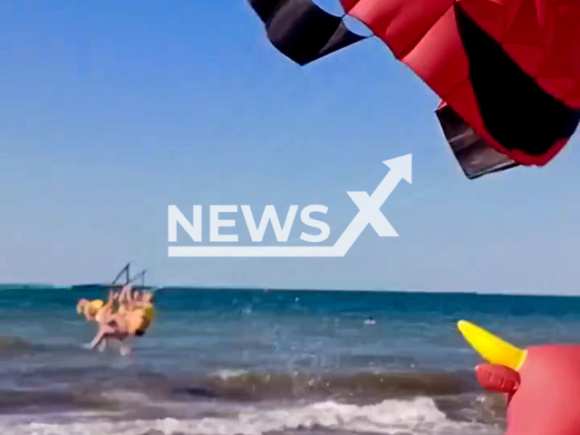 This image is a screen grab of the video supplied titled NewsX-ParachutedTourist-01.mp4: Footage shows several people being dragged by a parachute over the sea, with one woman left unconscious after suffering a severe head injury due to a faulty mount during a parasailing ride in Krasnodar Krai, Russia on Friday, June 27, 2025.