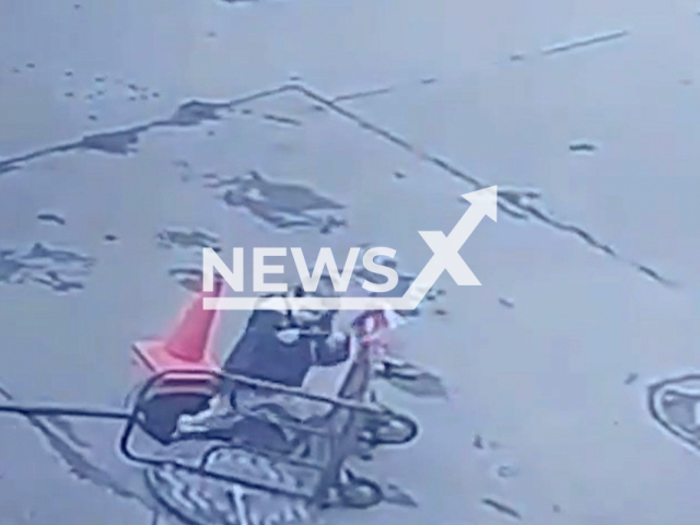 This image is a screen grab of the video supplied titled NewsX-OpenManhole-01.mp4: A 4-year-old boy distracted by his phone fell into an 8-meter open manhole in parking lot, prompting his father to jump in after him in a St. Petersburg, Russia on Thursday, July 10, 2025.(Clipzilla/NX)