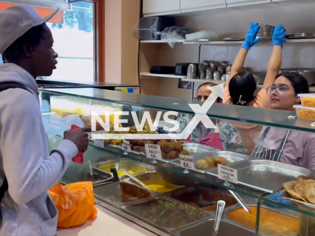 A man eats chicken at a vegetarian restaurant in London, UK, undated. After critics, he apologised for his act. Note: Photo is a screenshot from a video. (Newsflash/NX)