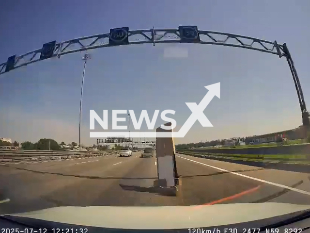 This image is a screen grab of the video supplied titled NewsX-CarBoard-01.mp4: Loose cardboard sheet flies off a moving vehicle and strikes the windshield of the car behind  in Saint Petersburg, Russia on Saturday, July 12, 2025.(Clipzilla/NX)
