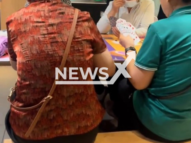Elderly people play cards at McDonald's in Shanghai, China, undated. Citizens complained as they occupied the tables for too long. Note: Photo is a screenshot from a video. (AsiaWire/NX)