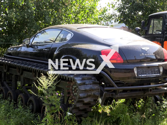 This image is a screen grab of the video supplied titled NewsX-BentleyTracks-01.mp4: Footage shows a Bentley on caterpillar tracks and police raid on Shafirovsky Highway at the famous auto blogger AcademeG, repair shop in Saint Petersburg, Russia on Wednesday, July 30, 2025.(Clipzilla/NX)