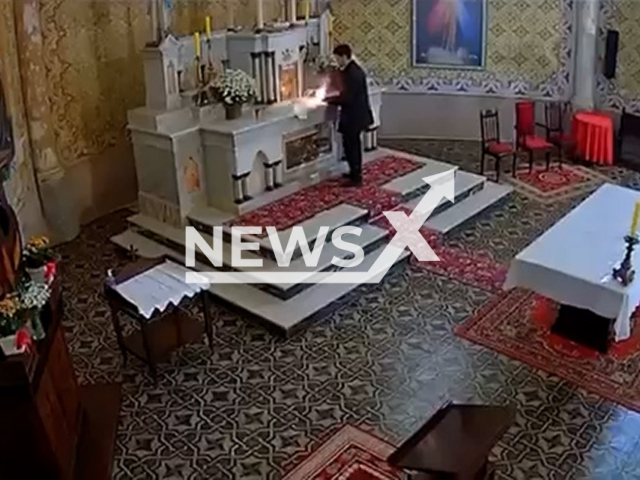 A man invades the Santo Estanislau Parish Church in Itaiopolis, Brazil, on Jul.30,2025. He lighted some type of explosive. Note: Photo is a screenshot from a video. (Newsflash/NX)