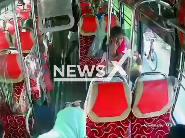 This image is a screen grab of the video supplied titled NewsX-SmallyBus-01.mp4: CCTV footage shows a child slipping from her mother’s arms and tumbling down the front steps of a bus after the driver suddenly braked near Meenakshipuram Junction, Srivilliputhur, India on Friday, Aug 1, 2025.(Clipzilla/NX)