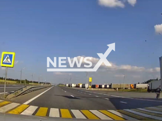 This image is a screen grab of the video supplied titled NewsX-TruckFailCrash-01.mp4: Dash camera shows truck knocking down cyclist on highway near village Nikolskoye, Chuvash Republic, Russia on Wednesday, July 30, 2025.(Clipzilla/NX)