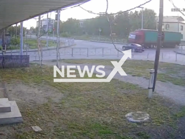 This image is a screen grab of the video supplied titled NewsX-RoadTruckSmash-01.mp4: Car speeding trying to cross the intersection on red but it gets smashed by the truck in Kamen-na-Obi,  Altai Krai, Russia on Wednesday, July 30, 2025.(Clipzilla/NX)