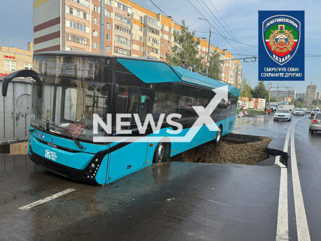 A photo shows a trolleybus stuck in a large hole after the asphalt collapsed at the intersection of Sakharov and Zakiyev streets in Kazan, Tatarstan, Russia, on Sunday, Aug. 3, 2025.
Note: Police photo.
(Clipzilla/NX)