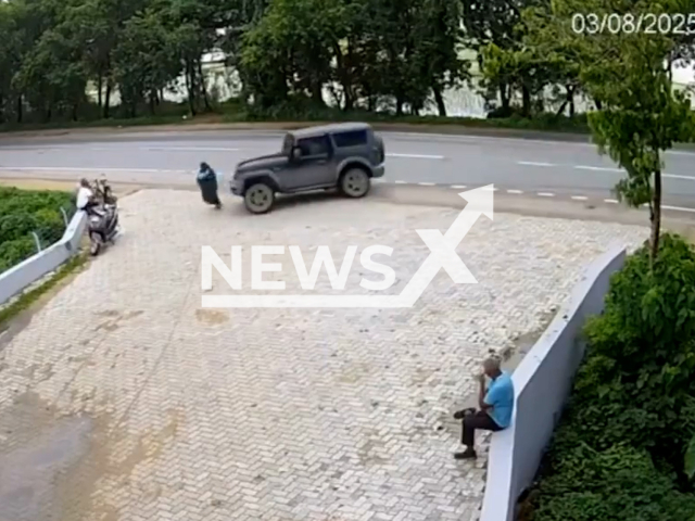 This image is a screen grab of the video supplied titled NewsX-TharRam-01.mp4: CCTV footage shows Thar losing control before ramming into woman walking and people sitting by the roadside in Rohtas district, Bihar, India on Sunday, Aug 3, 2025.(Clipzilla/NX)