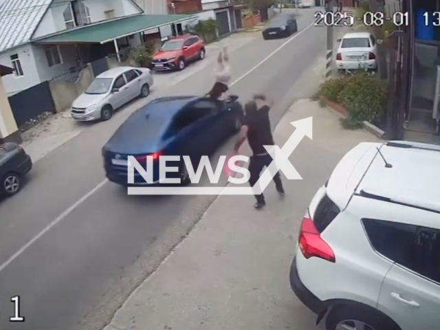 This image is a screen grab of the video supplied titled NewsX-LadyHit-01.mp4: CCTV footage shows a car hitting a 44-year-old woman as she attempted to cross an unregulated section of the road in the village of Sergey-Pole, Sochi in the Krasnodar region of Russia on Friday, Aug 1, 2025.(Clipzilla/NX)