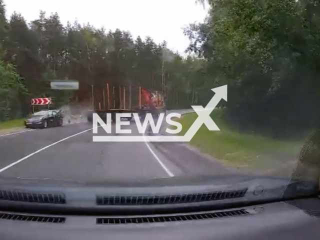 This image is a screen grab of the video supplied titled NewsX-OppLorry-01.mp4: Dashcam shows lorry trailer side-swiping a car coming from the opposite direction near the village of Kriusha in the Ryazan region, Russia, on July 1, 2025. (Clipzilla/NX)