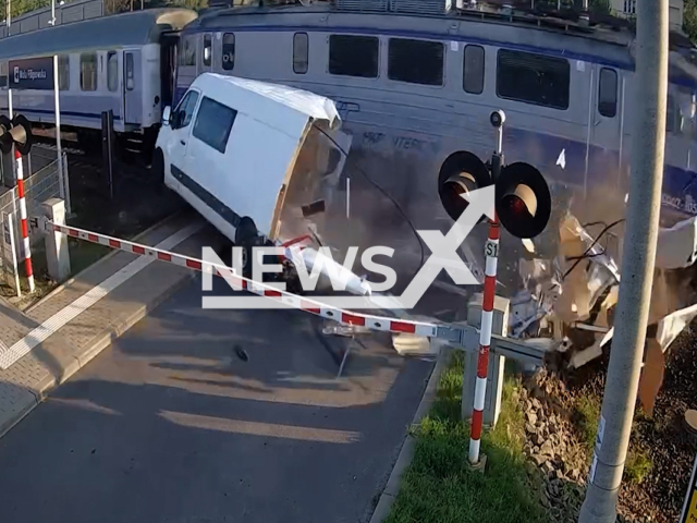 This image is a screen grab of the video supplied titled NewsX-TrapTrain-01.mp4: Footage shows a white van being smashed by a speeding passenger train after getting stuck on the tracks in Wola Filipowska, Poland, on Friday, August 1, 2025.(@Malopolska.Policja/Clipzilla/NX)