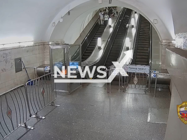 This image is a screen grab of the video supplied titled NewsX-SubwayStunt-01.mp4: CCTV shows a young man rides on the handrail of the escalator and broke one of the lampshades at the Park Kultury metro station,  Moscow, Russia on Wednesday, Aug 6, 2025.(Clipzilla/NX)