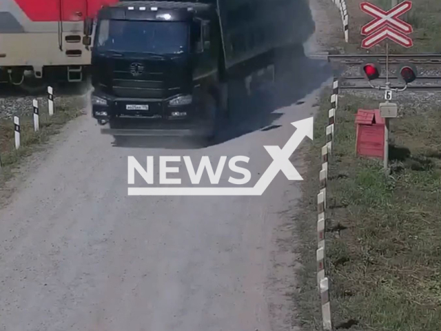 This image is a screen grab of the video supplied titled NewsX-TruckTrack-01.mp4: CCTV shows train crashing into a truck on the railway tracks in Bogdanovich in Sverdlovsk Oblast, Russia on Wednesday, Aug 6, 2025.(Clipzilla/NX)