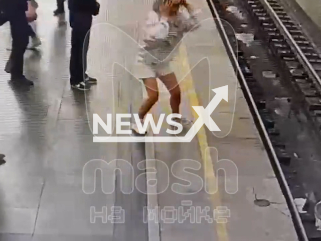 This image is a screen grab of the video supplied titled NewsX-MetroScare-01.mp4: Footage shows a baby carriage felling onto the metro tracks and crushed by the train while the child was safe in the arms of the mother in Saint Petersburg Metro, Russia on Thursday, Aug 7, 2025.(Clipzilla/NX)