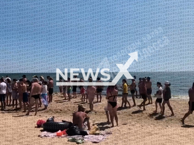 This image is a screen grab of the video supplied titled NewsX-MineExplosion-01.mp4: Footage shows people on the beach where the mine exploded and killed 3 people in Odesa, Ukraine on Sunday, Aug 10, 2025.(Clipzilla/NX)