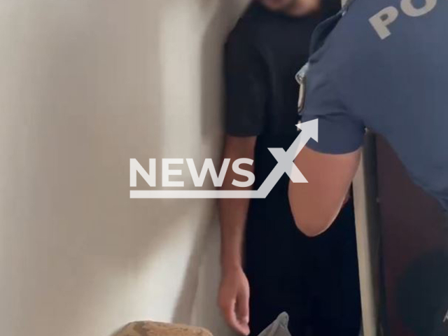 This image is a screen grab of the video supplied titled NewsX-FugitiveHide-01.mp4: Footage shows fugitive sentenced to 33 years in prison caught behind a shelf in his home by police officers in Edirne, Turkey on Thursday, Aug 7, 2025.(Clipzilla/NX)