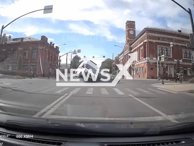 This image is a screen grab of the video supplied titled NewsX-CitroenAndAmbulance-01.mp4: Dash camera shows an ambulance speeding on red light through intersection and colliding with Citroen in Cherepovets, Vologda Oblast, Russia on Friday, Aug 8, 2025.(Clipzilla/NX)