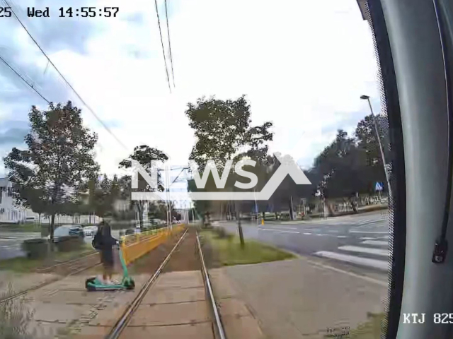This image is a screen grab of the video supplied titled NewsX-TramCollide-01.mp4: Dash cam footage shows a tram colliding with 19-year-old riding an electric scooter across a pedestrian crossing while wearing headphones in Szczecin, Poland, on Wednesday, Aug 6, 2025.(Clipzilla/NX)