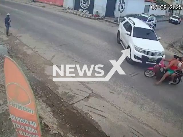 Video shows collision between car and motorcycle with two women and a child in Penedo, Brazil, Aug. 7, 2025. The 24-year-old woman suffered a fracture, and the 23-year-old woman suffered bruises. Note: Photo is a screenshot from a video. (Newsflash/NX)