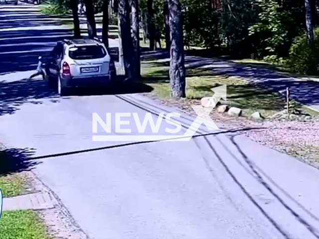 This image is a screen grab of the video supplied titled NewsX-StreetRun-01.mp4: Footage shows a car hitting a two-year-old boy who rans out onto the road in the village of Pesochny in the Kurortny District of St. Petersburg, Russia on Saturday, Aug 9, 2025.(Clipzilla/NX)