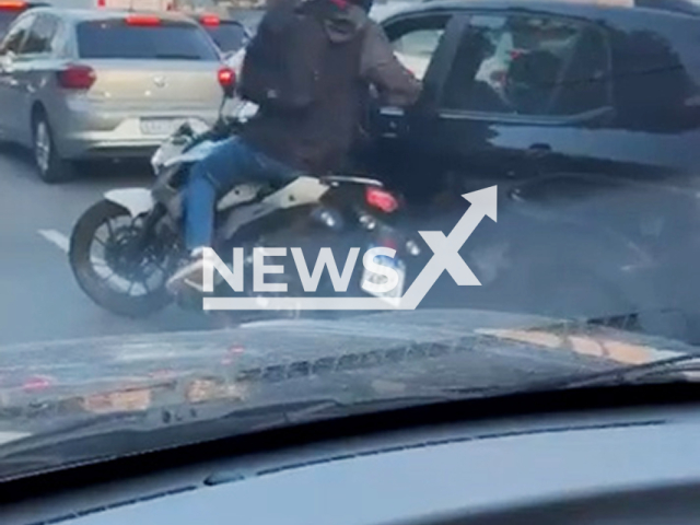A driver takes the robber's gun and shoots at him in Sao Paulo, Brazil, on Aug.12, 2025. The thief fell from the bike. Note: Photo is a screenshot from a video. (Newsflash/NX)